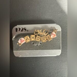 1928 “Amore" cherub and rose brooch